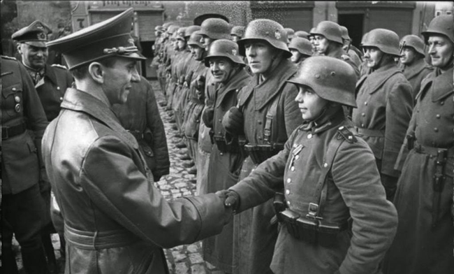 30.) Joseph Goebbels and a young German recruit in 1945.