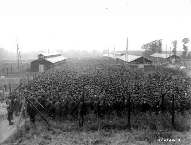 26.) German POWs packed into a prisoner camp.