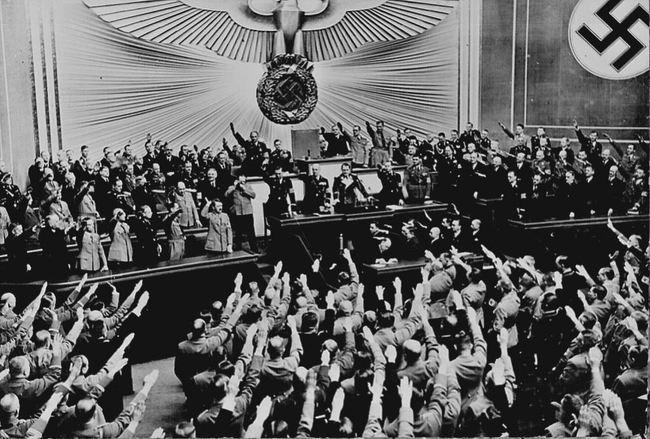 8.) Applause and salutes for Hitler after Germany successfully annexed Austria in 1938.