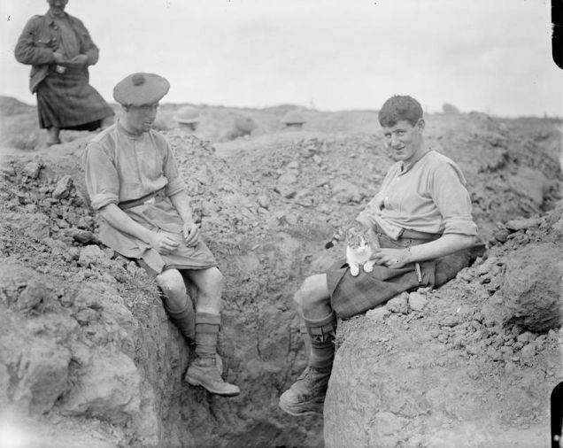 5.) A couple of Scottish soldiers in the 9th Battalion, Gordon Highlanders, with their pet cat, Martinpuich.