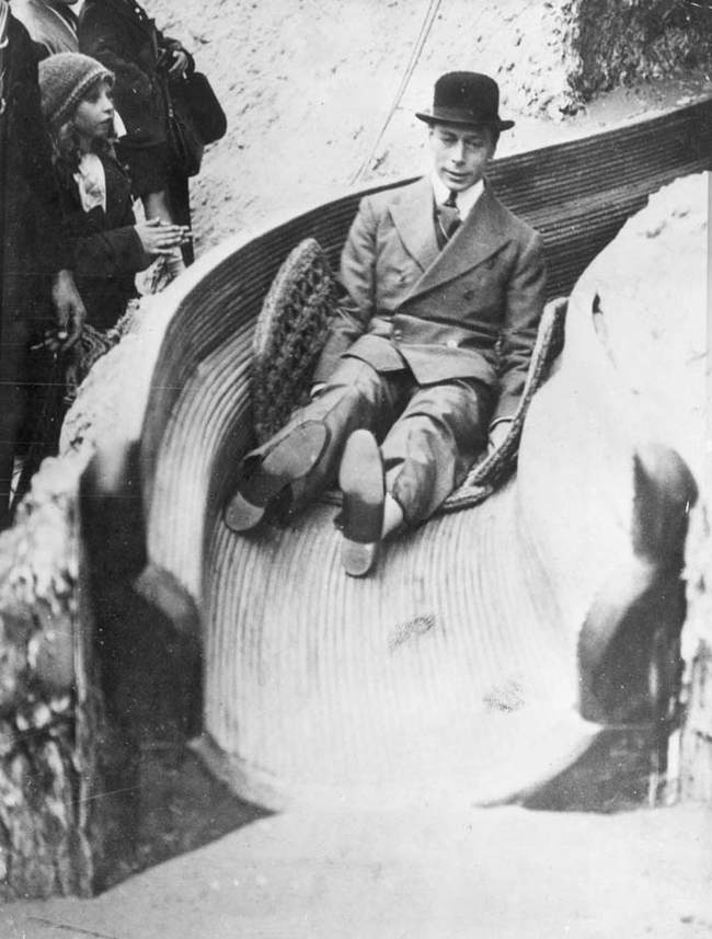 9.) King George VI of England enjoys himself on a slide.